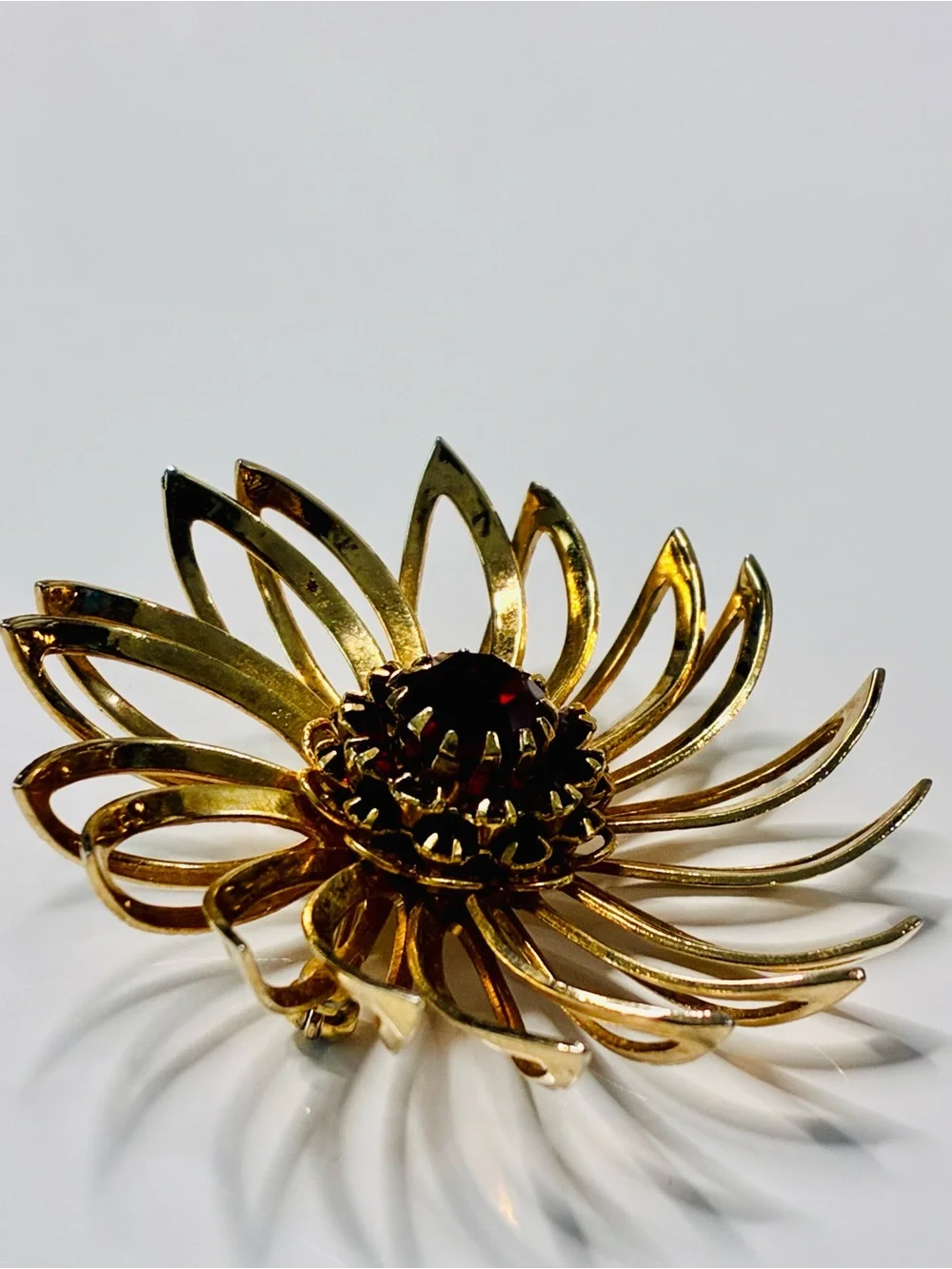 Sarah Coventry Gold-tone Sunburst Brooch with Deep Red Center